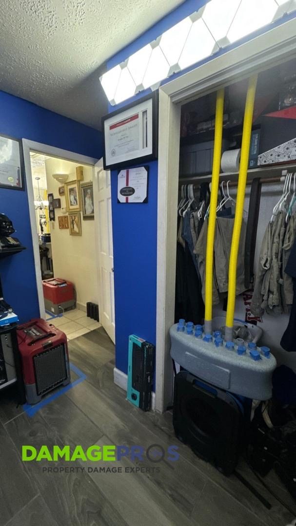 Structural drying equipment set up in a closet after water damage